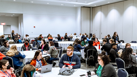 Educational session room with attendees at tables