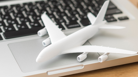 Model airplane sitting on laptop